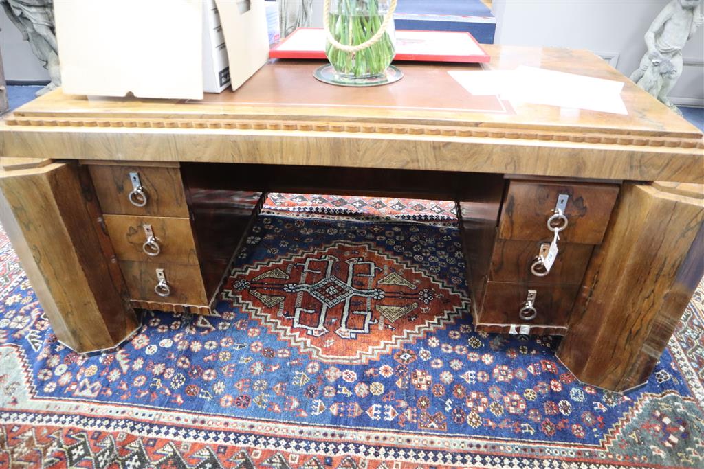 A French Art Deco rosewood desk in the manner of Paul Follot